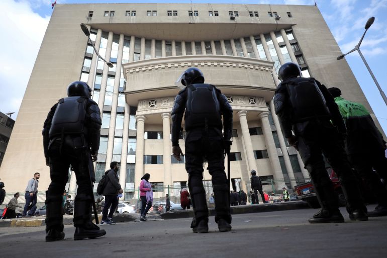 Egyptian security forces stand guard outside a courthouse.