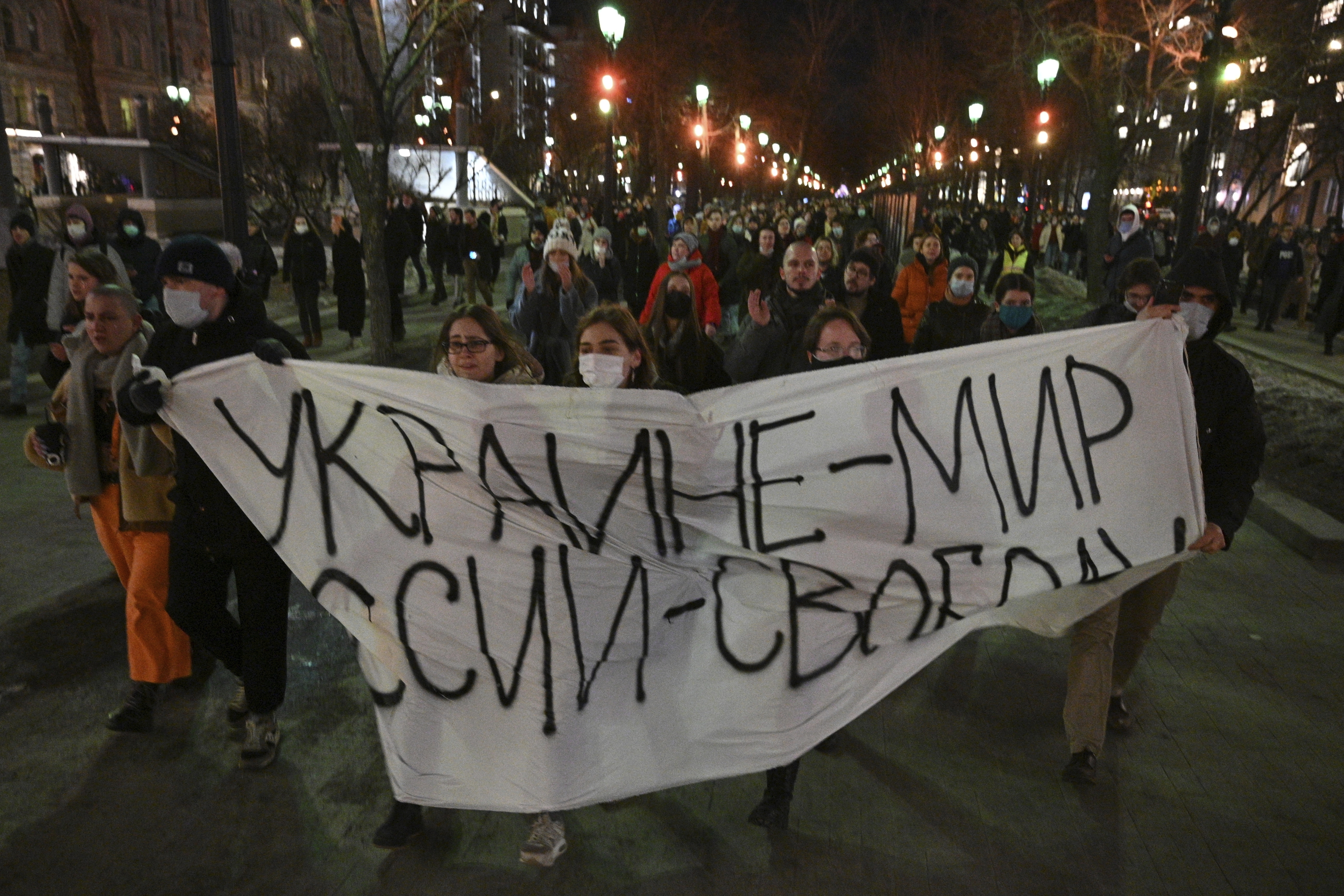 Demonstrators march with a banner that reads: "Ukraine - Peace, Russia - Freedom", in Moscow