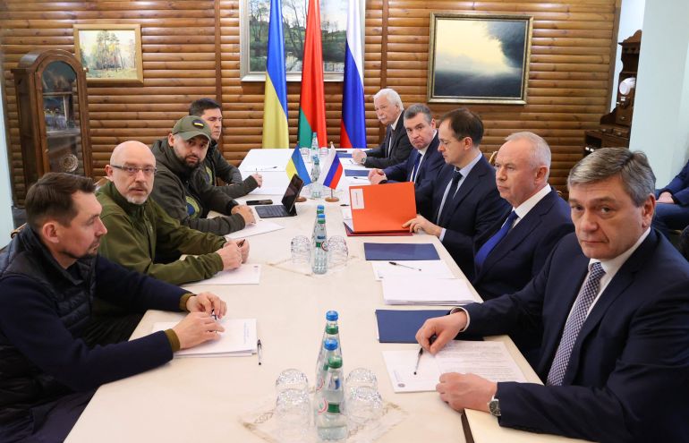 Deputy Minister of Foreign Affairs of Ukraine Mykola Tochytskyi, left, Minister of Defense of Ukraine Oleksiy Reznikov, second left, the Head of the Ukrainian Servant of the People faction Davyd Arakhamia, third left, Adviser to the Head of the Office of the President of Ukraine Mykhailo Podoliak, fourth left, Russian Ambassador to Belarus Boris Gryzlov, fifth right, Leonid Slutsky, chairman of the Russian State Duma's International Affairs Committee, fourth right, Russian Presidential Aide and the head of the Russian delegation Vladimir Medinsky, third right, Deputy Minister of Defense Alexander Fomin, second right, and Deputy Foreign Minister Andrei Rudenko pose prior the talks between delegations from Ukraine and Russia in Belarus' Brest region. 