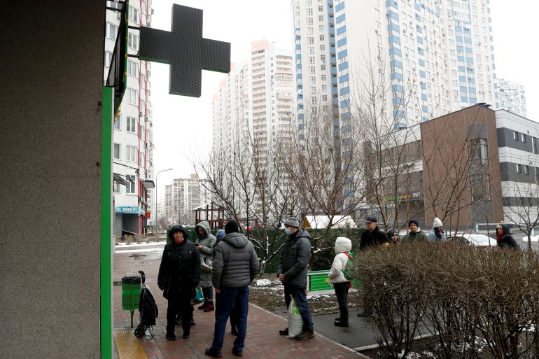 People line up in front of a pharmacy in Kyiv