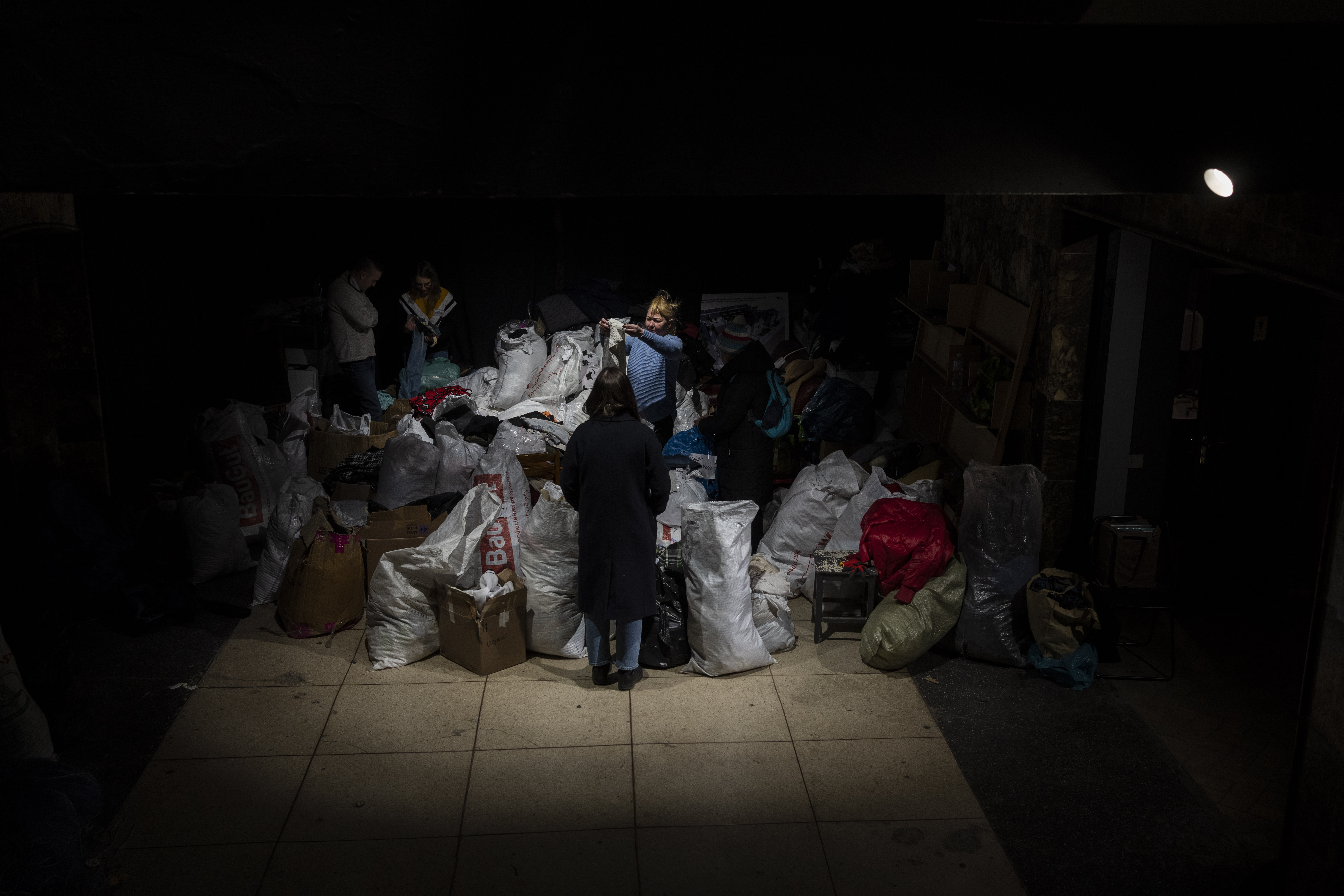 Volunteers sort donated clothes for later distribution among internally displaced people in Lviv