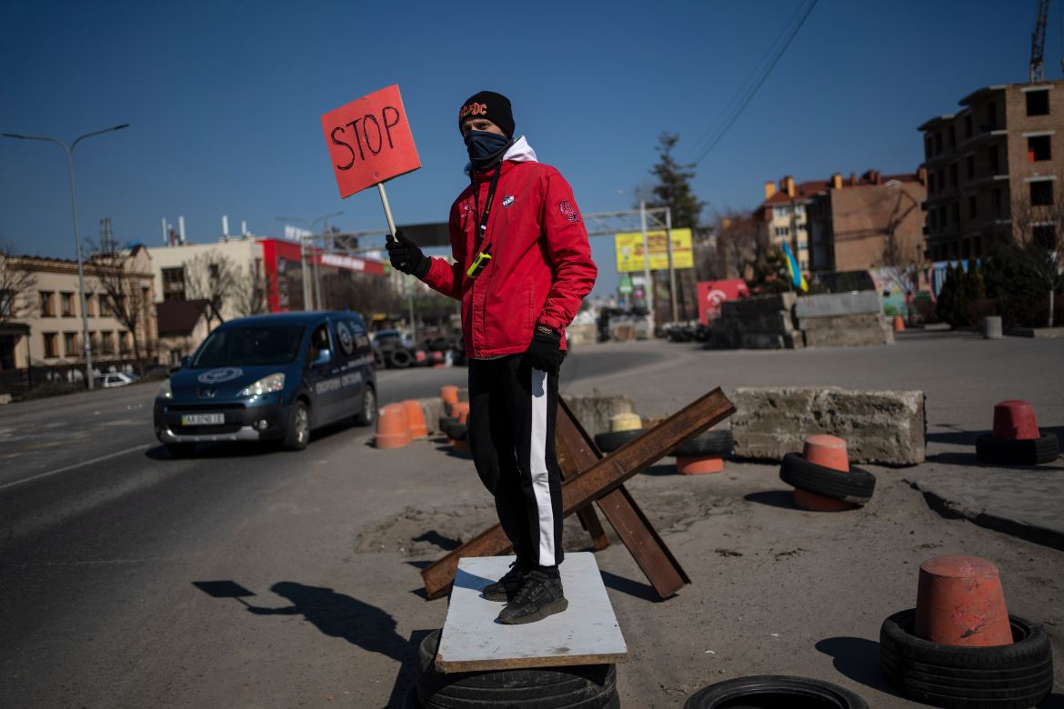 A neighbor works as a traffic officer at one of the barricades built by territorial defense units in the outskirts of Kyiv