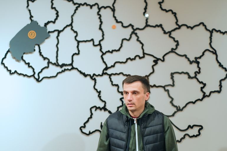 Ivan Sopko is a Ukrainian man who has a picture of a map behind him 