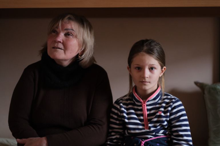 A photo of a woman and a child next to her.