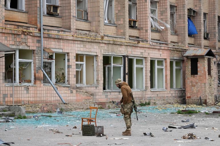 A Ukrainian soldier stands near a state-run nuclear waste department near the Chernobyl nuclear power plant.