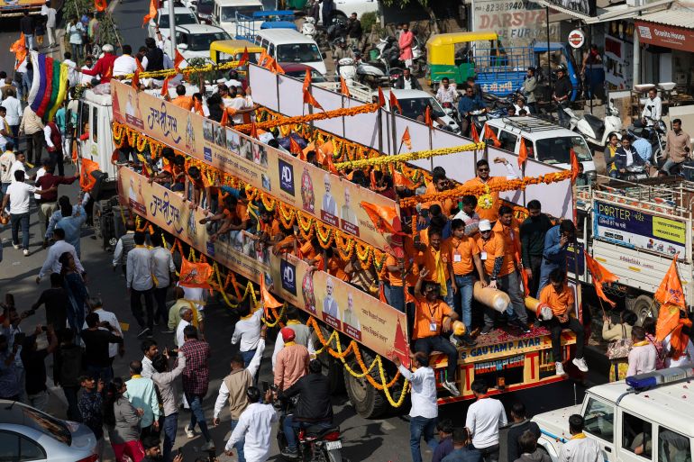 Hindu devotees transport flag poles expected to be installed at the Hindu Ram Temple in the northern town of Ayodhya ahead of the temple's inauguration ceremony, in a decorated truck trailer through a street in Ahmedabad, India, January 5, 2024. REUTERS/Amit Dave