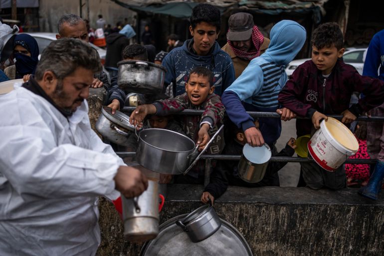 Palestinians line up for food in Rafah, Gaza Strip