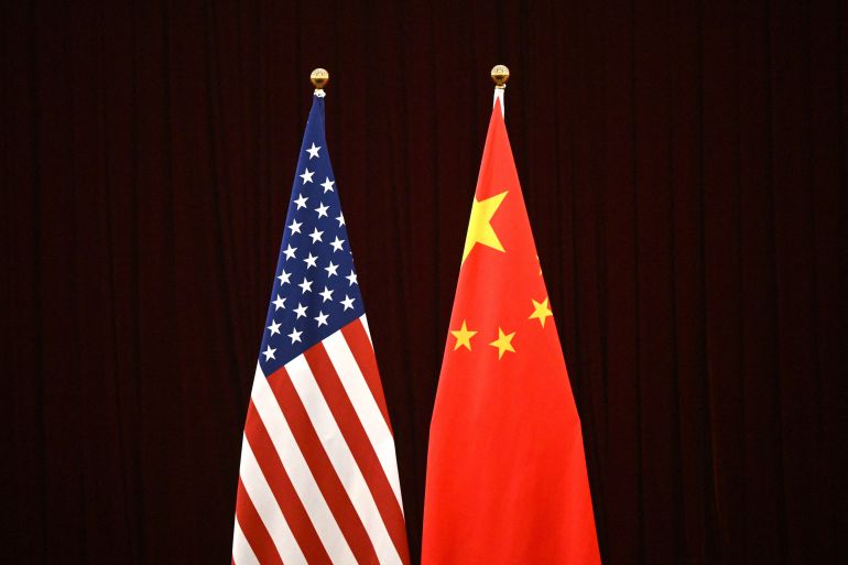 US and China flags against a black backdrop