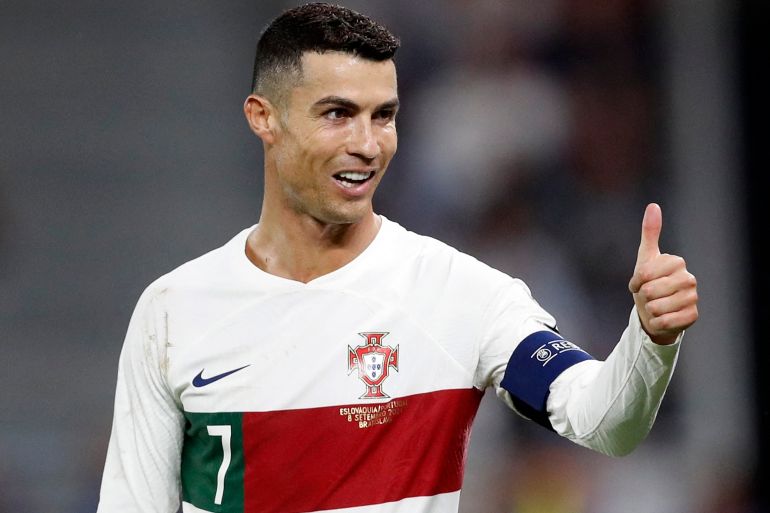 Ronaldo makes a thumbs up gesture during a football match