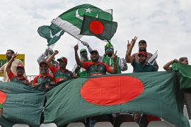 Bangladesh and Pakistan fans wave their national flags