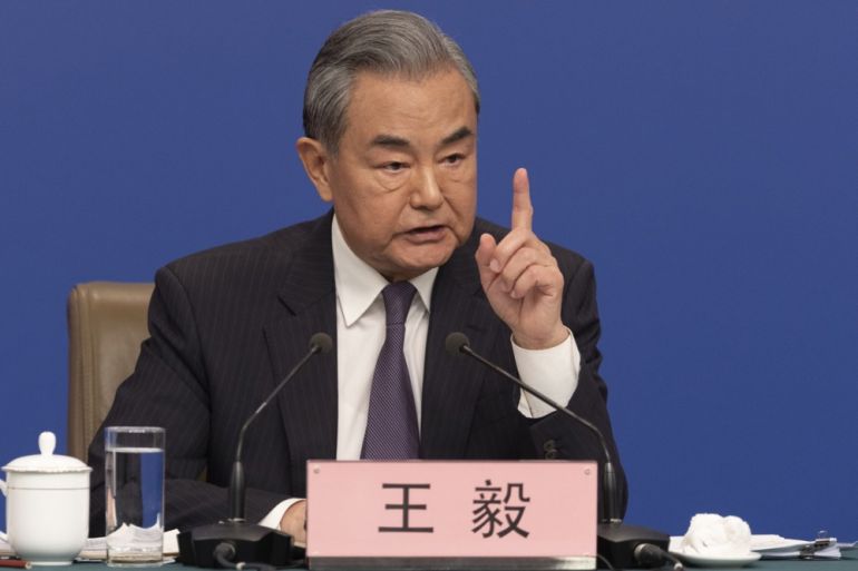 China’s Foreign Minister Wang Yi gestures during a news conference.