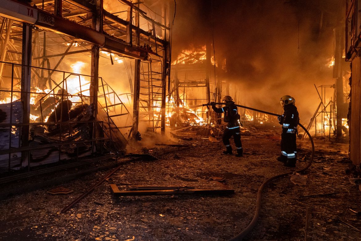 Firefighters tackle the blaze after a Russian air attack that hit at Barabashovo market in Kharkiv, Ukraine,