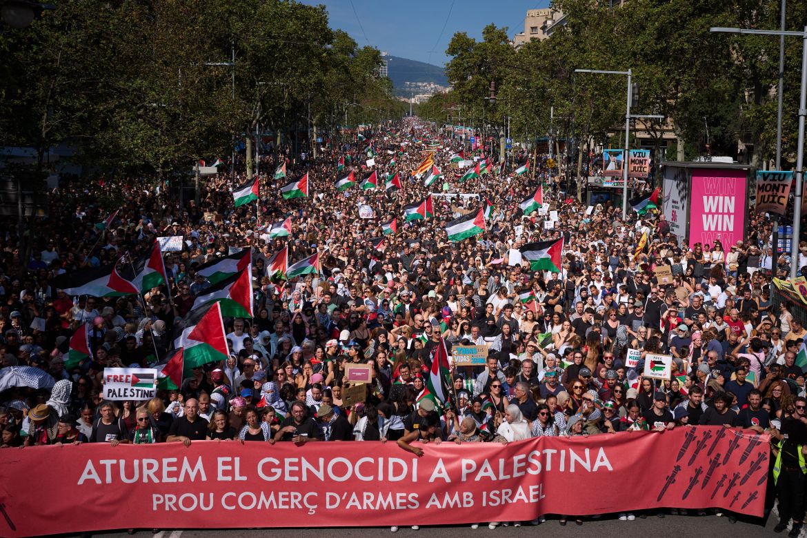 Demonstrators hold a banner with writing reading in Catalan "Let’s stop the genocide in Palestine, no more arms trade with Israel”" during a pro-Palestinian rally in solidarity with the Global Sumud Flotilla after ships were intercepted by the Israeli navy, in Barcelona, Spain