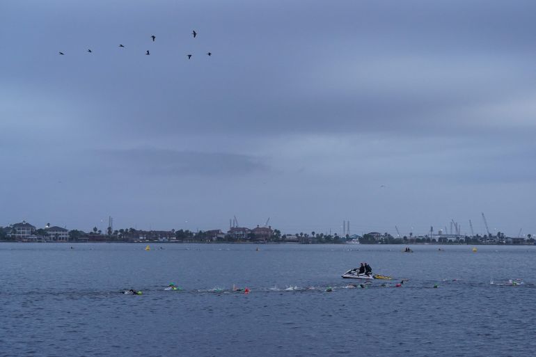 Age group athletes compete in the swim course at IRONMAN 70.3 Texas on April 7, 2024 in Galveston, Texas.
