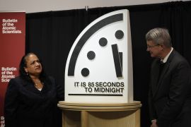 The Bulletin of the Atomic Scientists members, Asha M. George, left, and Steve Fetter, right, stand next to the Doomsday Clock, set to 85 seconds to midnight, during a news conference at the Carnegie Endowment for International Peace, Friday, Jan. 23, 2026, in Washington. (AP Photo/Pablo Martinez Monsivais)