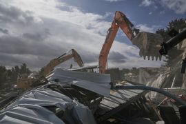 Israeli bulldozers demolish a UNRWA compound, belonging to the U.N. agency that assists Palestinian refugees, in east Jerusalem Tuesday, Jan. 20, 2026. (AP Photo/Mahmoud Illean)
